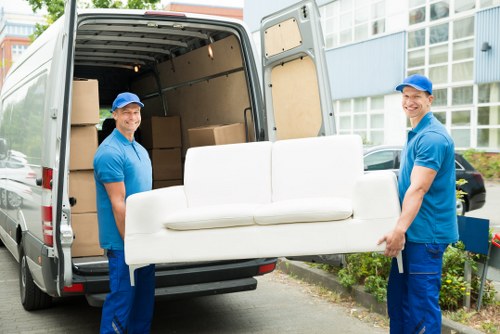 Man with van service in Highbury loading boxes into a van